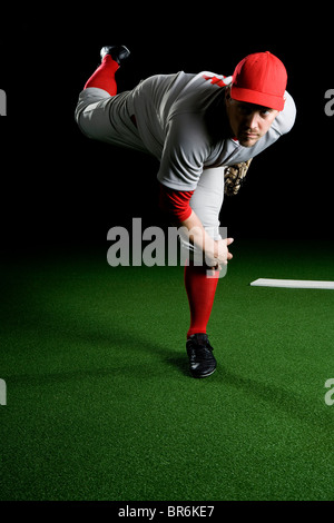 a baseball pitcher throwing a pitch with copy space Stock Photo - Alamy