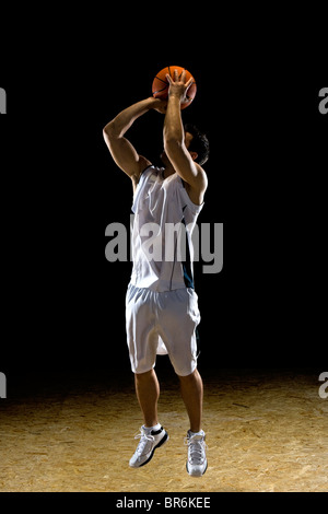 A basketball player preparing to take a shot Stock Photo