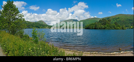 Panoramic view looking across Grasmere towards Helm Crag and Fairfield in summer Cumbria Lake District National Park England UK United Kingdom Britain Stock Photo