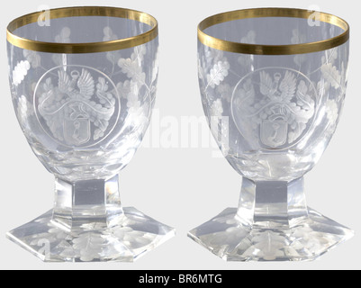 Hermann Göring - two liqueur glasses, from a hunter's table service. Cut and faceted crystal glass with gold rim. The Göring family arms surmounted by a helmet is set in a medallion, surrounded by oakleaf decoration. Six-sided stems on six-sided feet (one chipped). Height 8 cm. Provenance: Voluntary auction of the former possessions of Hermann Göring, Neumeister, formerly Weinmüller, 157th auction, 25 October 1974, most likely also ex lot 3061. Presumably a gift for Göring's 50th birthday on 12 January 1943. historic, historical, 1930s, 20th century, NS, Nation, Stock Photo