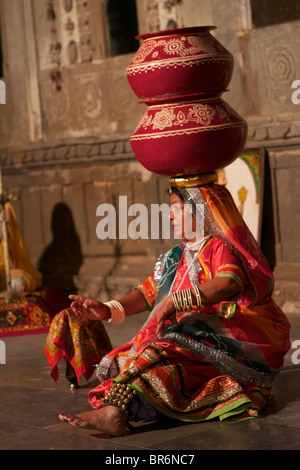 indian woman dancing with jars on head in a rajasthan show Stock Photo