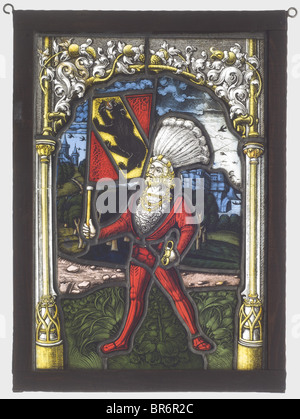 A coat of arms leaded glass panel, Switzerland, middle of the 16th century. Flashed glass in various colours with fine 'Schwarzlot'-painting. A standing ensign in an early Lansknecht-costume with sword. In his right hand a flag displaying the coat of arms of the City of Bern. In the background a wide landscape. Arch-like framing of late Gothic tracery and tendril decoration. Reconditioned lead glazing, some cracked panels. In a wooden frame of the 19th century. Dimensions 35 x 25 cm. historic, historical, people, 16th century, handicrafts, handcraft, craft, obj, Stock Photo