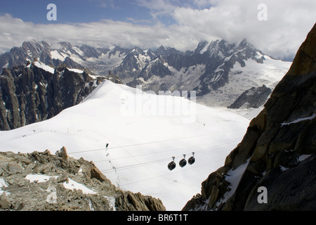Cable cars leave from the Aiguille du Midi. French Alps. Stock Photo
