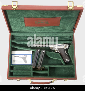 A Mauser Parabellum mod. 06/73, engraved, in its leather case, 9 mm Parabellum cal., no. 01. Mirror-like bore, barrel length 140 mm. Grip safety. Ornamental and vine engraving on all parts against a polished background. Small parts blue and yellow. Carved precious wood grip panels. Magazine matt chromed. New condition. Comes with accessory reddish brown Mauser leather case, dimensions 47 x 32 x 7 cm, inlaid with green velvet. Included: two blued spare magazines with wooden base, manual and case key. Erwerbsscheinpflichtig. historic, historical, 1970s, 20th cent, Stock Photo