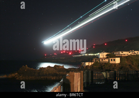 An airplane is landing on La Palma during the night (Canary Islands, Spain) Stock Photo