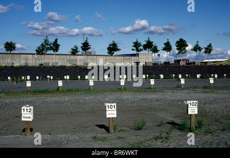 Employee parking lots of different companies at Shanghaiallee in Hamburg's Hafencity. Stock Photo