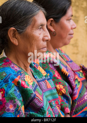 Two women from an indigenous community in Guatemala wearing traditional clothes in Antigua Guatemala. Stock Photo