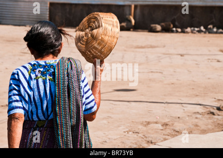 Indigenous woman, traditional dressed, walking down the streets of Santiago Atitlan village, Atitlan lake region, Guatemala. Stock Photo