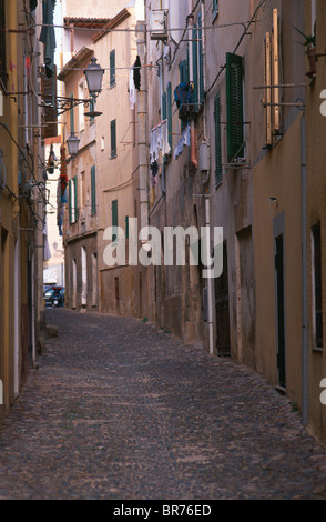 Narrow empty cobblestone street in Alghero, Sardinia, Italy. Stock Photo