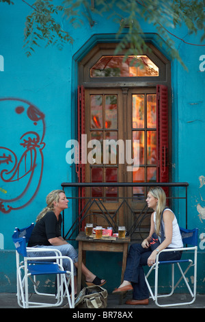 Two friends talk over a beer in Buenos Aires Argentina. Stock Photo