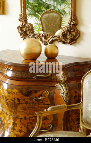 still life commode mirror chair Stock Photo
