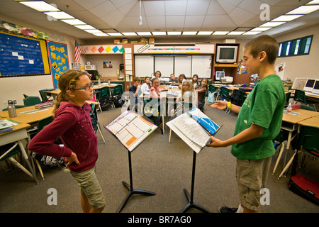 Working from notes, middle school students engage in a debate before their classmates in San Clemente, CA. Stock Photo