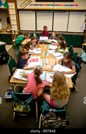 Students work at desks in a middle school class in San Clemente, CA. Stock Photo
