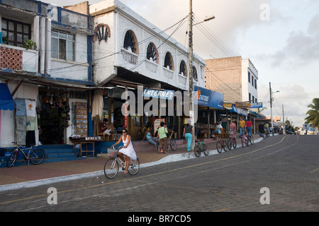 A typical street scene takes shape along Charles Darwin Avenue on the Puerto Ayora waterfront in the Galapagos. Stock Photo