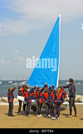 Young people sail training with a Laser Pico sailing dinghy at Weymouth and Portland Sailing Academy Dorset England Stock Photo