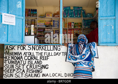 A woman buying from a local store Nungwi village Stock Photo