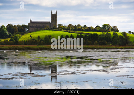 Downpatrick cathedral reflected in the waters of Quoile River in the grounds of Inch Abbey, County Down, Northern Ireland Stock Photo