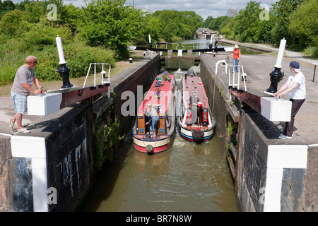 Two [narrow boats] entering a lock on the [Grand Union Canal) in Hatton Warwickshire Stock Photo