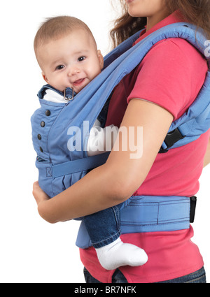 Mother with a four month old baby boy in a carrier. Isolated on white background. Stock Photo