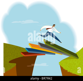 A man jumping over a chasm Stock Photo