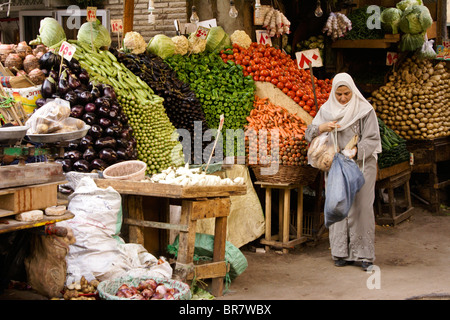 Muslim woman buying vegetables in market, Cairo, Egypt Stock Photo