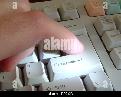 Finger Pressing Button on Computer Keyboard Stock Photo