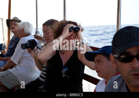 Tourists on board pleasure boat sightseeing, Paxos, Greece Stock Photo