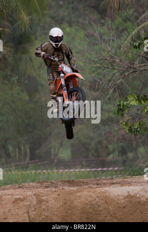 A rider jumps at a motocross event Stock Photo