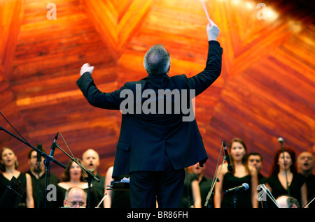 Andrew Bisantz conducts the Boston Landmarks Orchestra in a performance of Tosca during a concert at the Hatch Shell in Boston Stock Photo