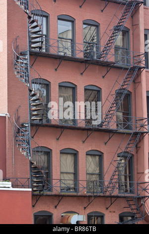 Old Fire escape stairs stairway Grand Rapids Michigan MI on the wall of building from below pictures from front view in USA US vertical hi-res Stock Photo