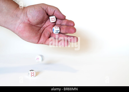 Hand rolling dice. Roll of the dice Stock Photo
