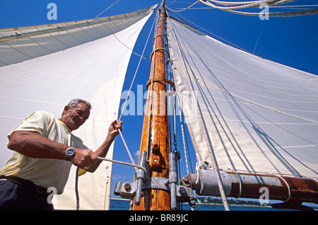 Eric Tabarly hauling the halyard aboard his classic yacht 'Pen Duick I'. Stock Photo