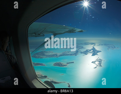 Aerial view through the window of a plane of the islands of Exuma, part of the chain of 365 islands that form the Bahamas. Stock Photo