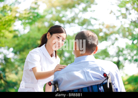 Nurse and man on wheelchair Stock Photo