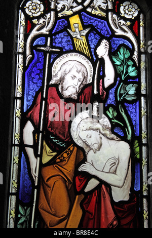 A stained glass window depicting the Baptism of Jesus, Clannaborough Church, Devon Stock Photo