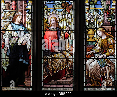 A stained glass window by Ward &Hughes depicting Jesus with Martha and Mary of Bethany, St Andrew's Church, Stratton, Cornwall