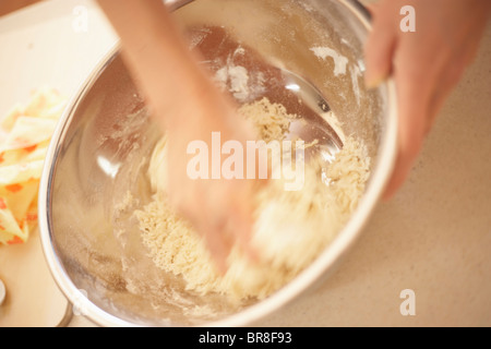 Woman making bagels, making dough, close up, blurred motion Stock Photo