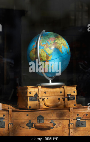 Display window of globe on antique leather suitcases at a shop in Denmark. Stock Photo