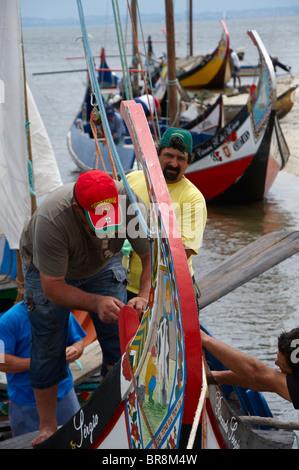 Fishermen in their traditional Moliceiro boat near Aveiro, Portugal Stock Photo