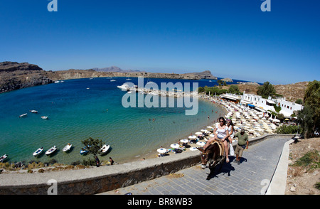 Tourists Riding Donkeys Up From Pallas Beach In Lindos Rhodes Greek Islands Greece Hellas Stock Photo