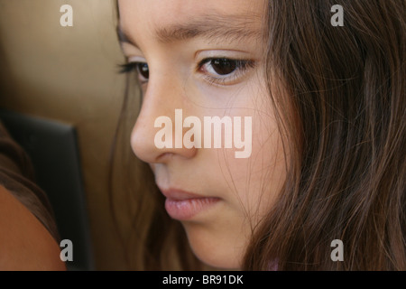 nine year old girl looking worried, closeup of face Stock Photo