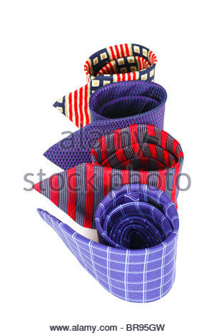 Four coloured patterned and striped Silk ties rolled up Stock Photo