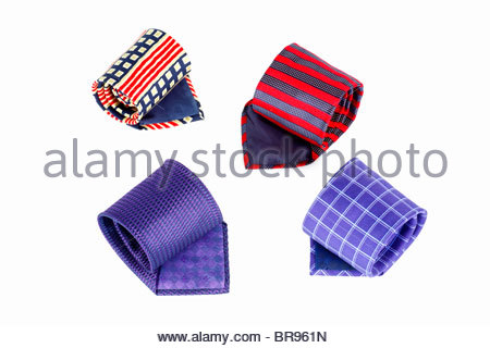 Four coloured patterned and striped Silk ties rolled up Stock Photo