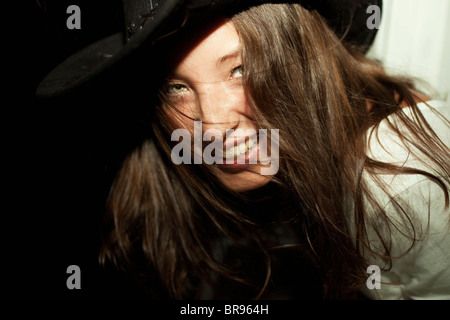 Portrait of young beautiful brunette woman wearing cowboy hat closeup