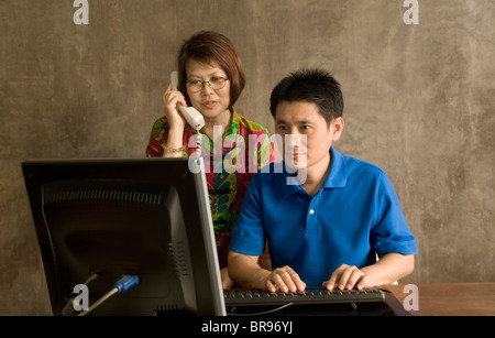 Asian couple using computer Stock Photo