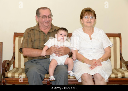 Merida, Yucatan/Mexico-July 8: Baby boy baptism celebration. Family group picture. Grandparents, from the father side, holding the baby Stock Photo