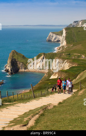 Family walking along the south west coast path, Lulworth Cove, Dorset, UK Stock Photo
