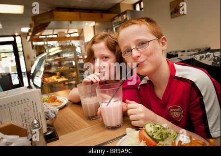 Eleven year old twin brother and sister drinking milkshakes in the soon to close National Milk Bar, Aberystwyth Wales UK Stock Photo