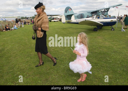 Retro fashion mother and daughter dressing living in the more glamorous fashionable past. Her hobby seen here at the  Revival Weekend at Goodwood Festival of Speed. Goodwood Sussex.  2010 2010s UK. HOMER SYKES Stock Photo