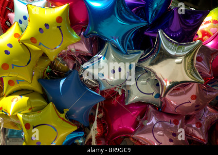 Smiling faces on colorful balloons;inflated happy face balloons;helium balloons;special occassion celebration balloons; Stock Photo